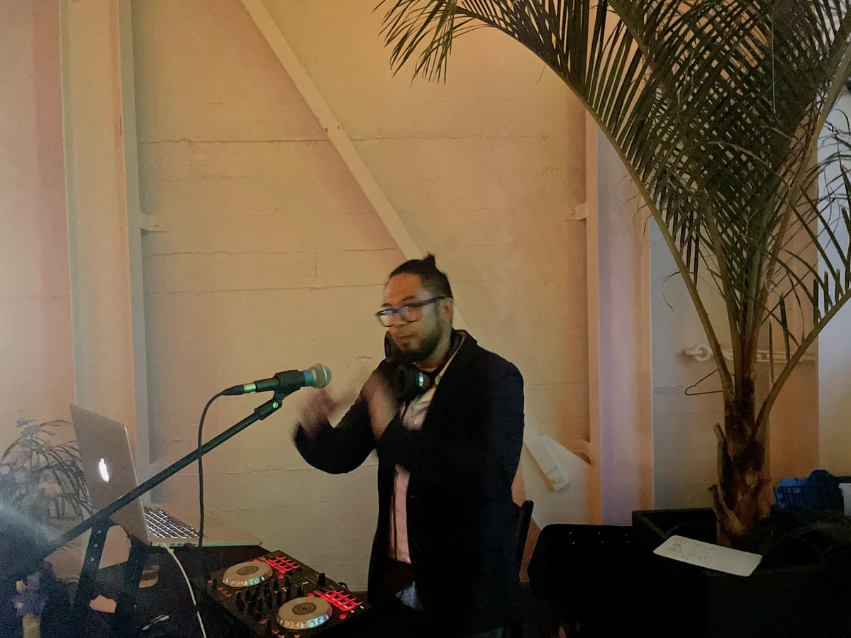 Aires working as a DJ at an event