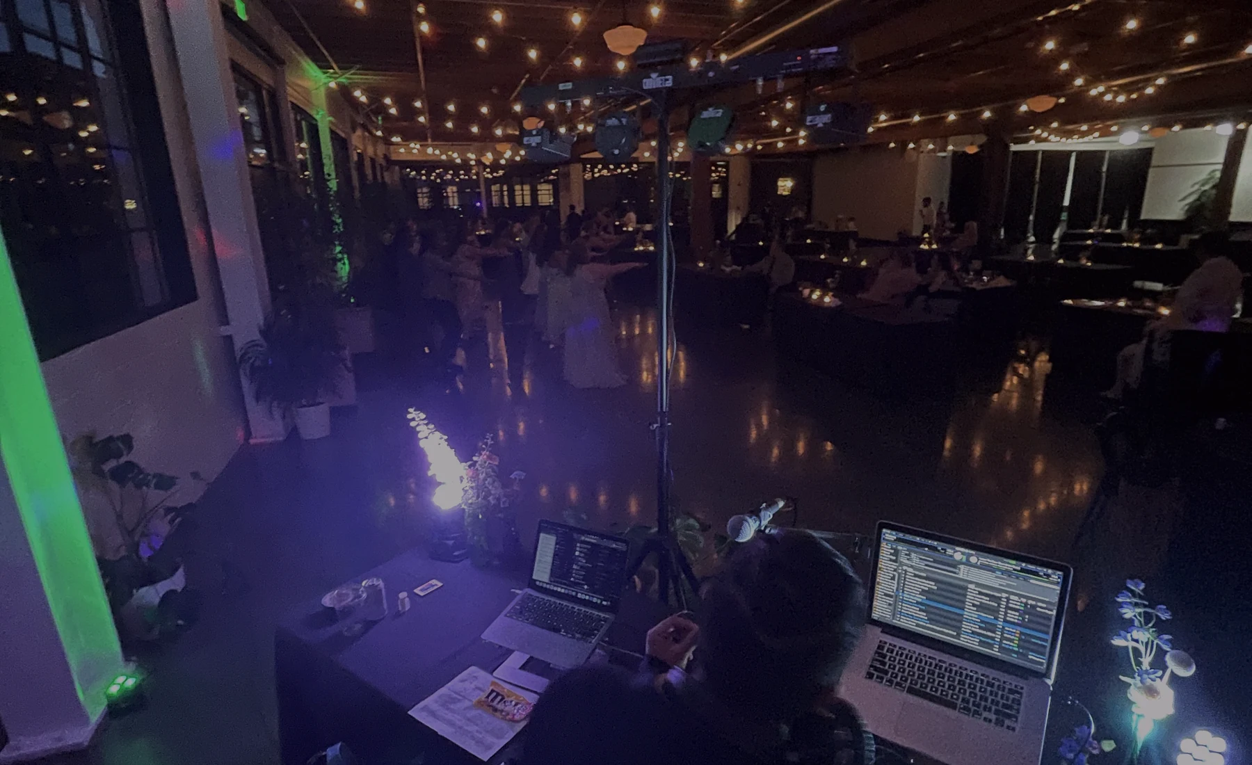 DJ setup and guests at a live reception