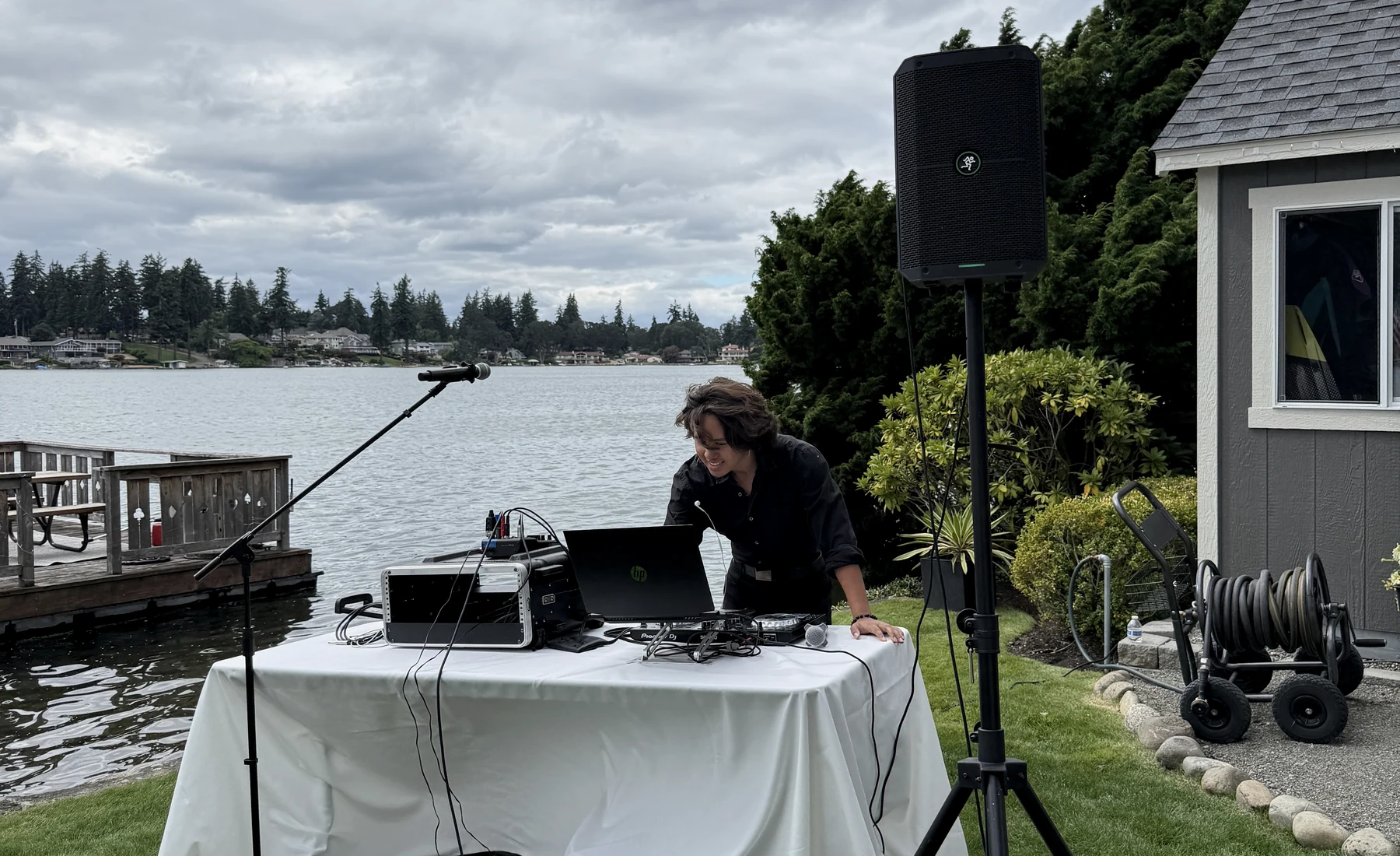 DJ setup at an outdoor wedding reception by the water